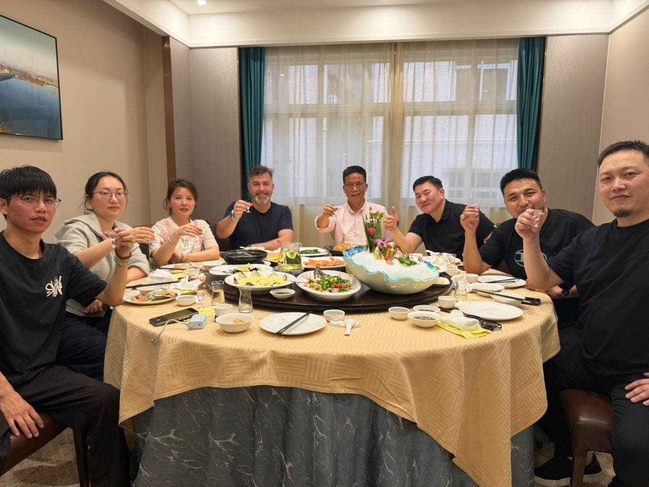 Transport Solutions and the Cartesy team gathered around a dinner table during a factory visit.